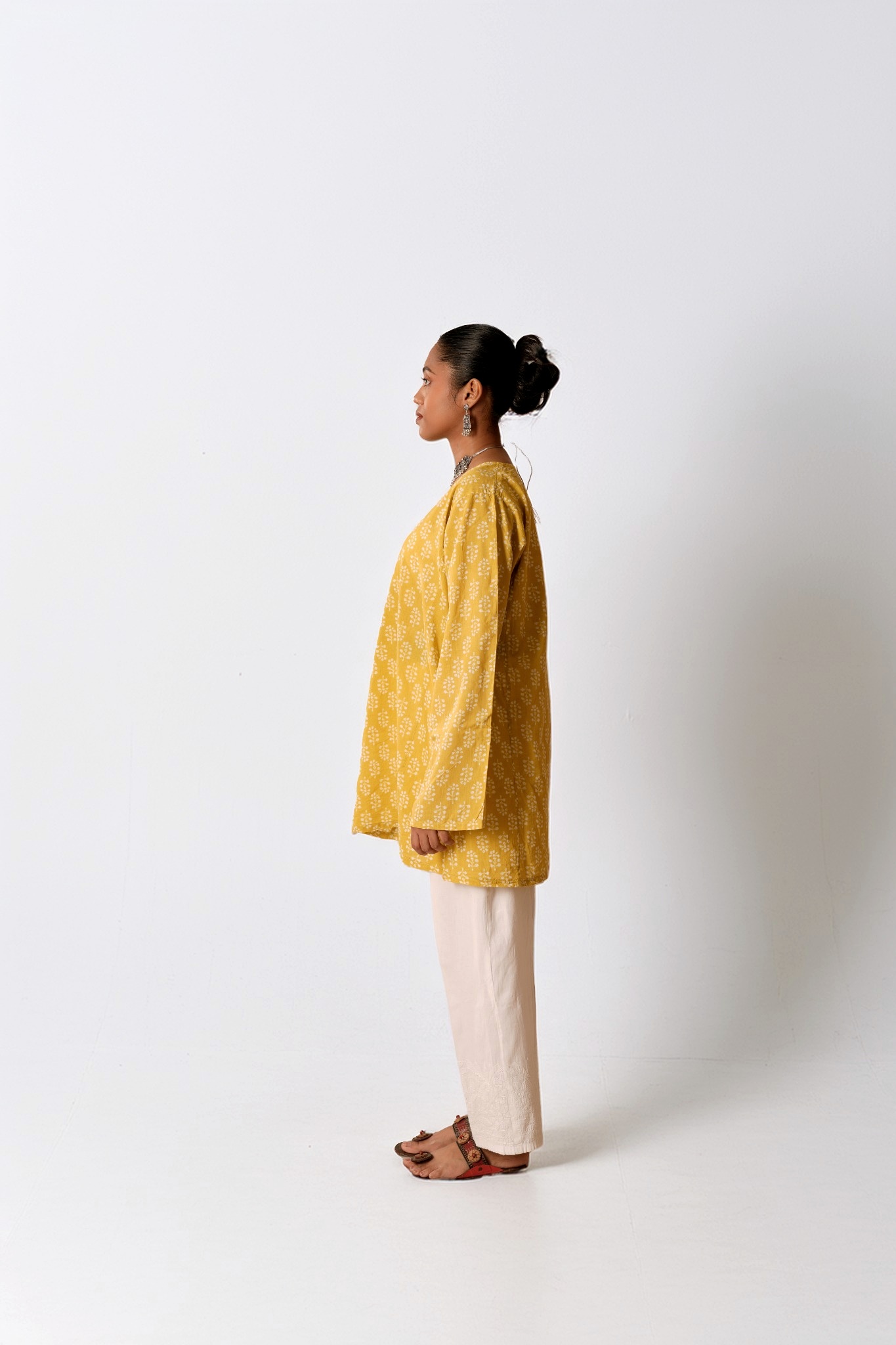 Full-length profile of a model in a yellow cotton set