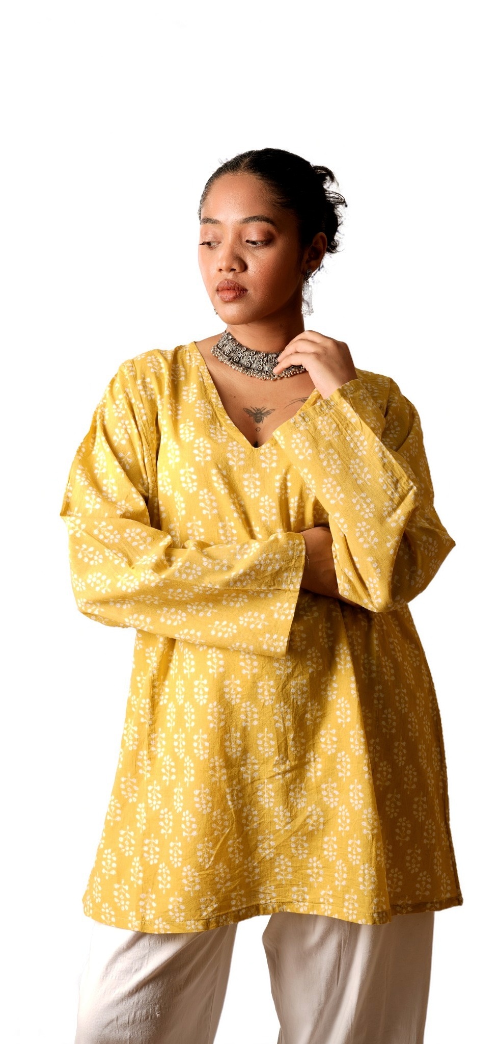 Portrait of a model in a yellow cotton set and jewellery