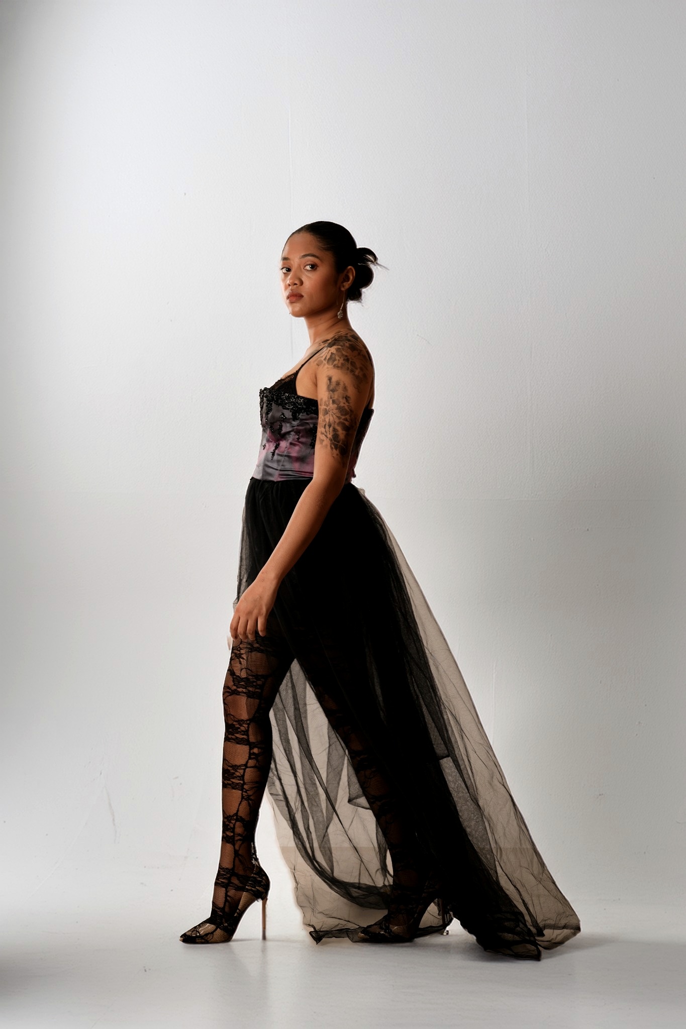 Full-length portrait in a layered black tulle look