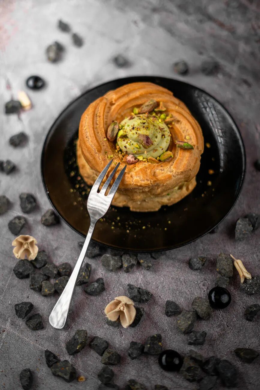Pistachio pastry on a black plate